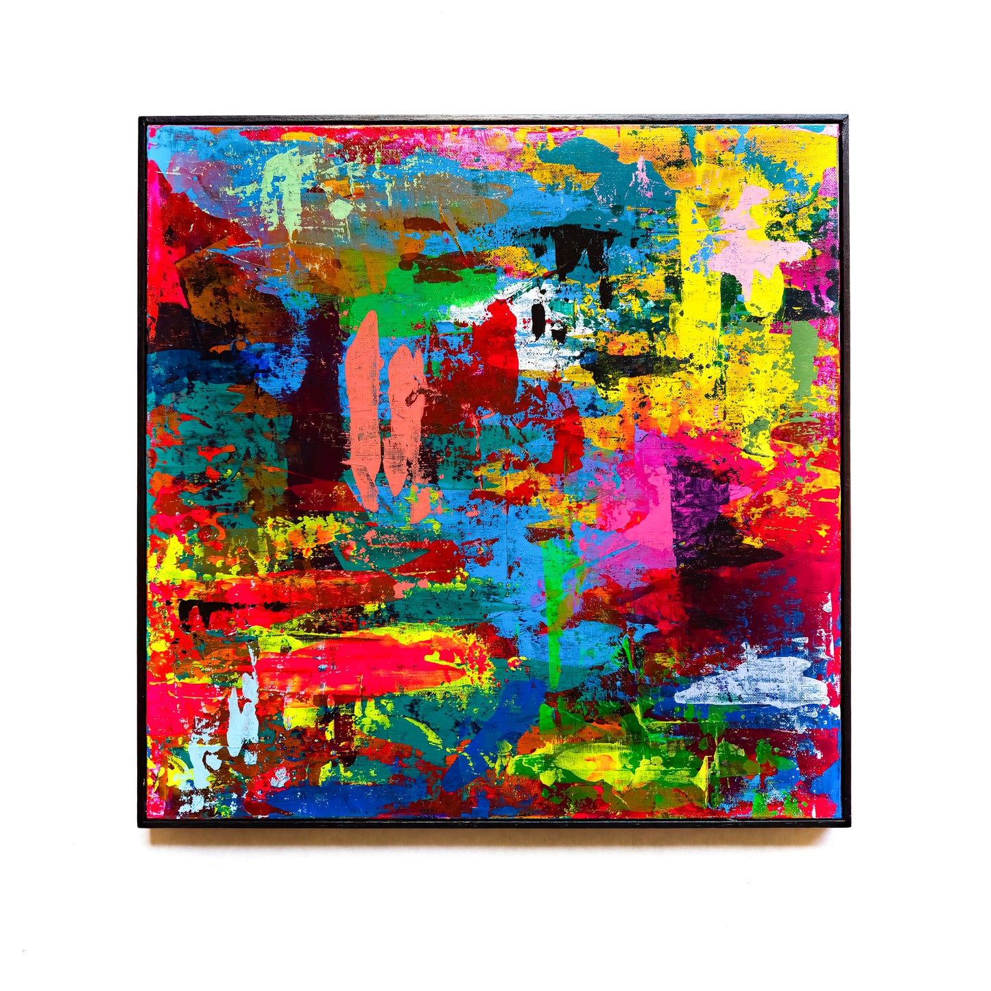 Abstract painting with vibrant colours on the white wall.