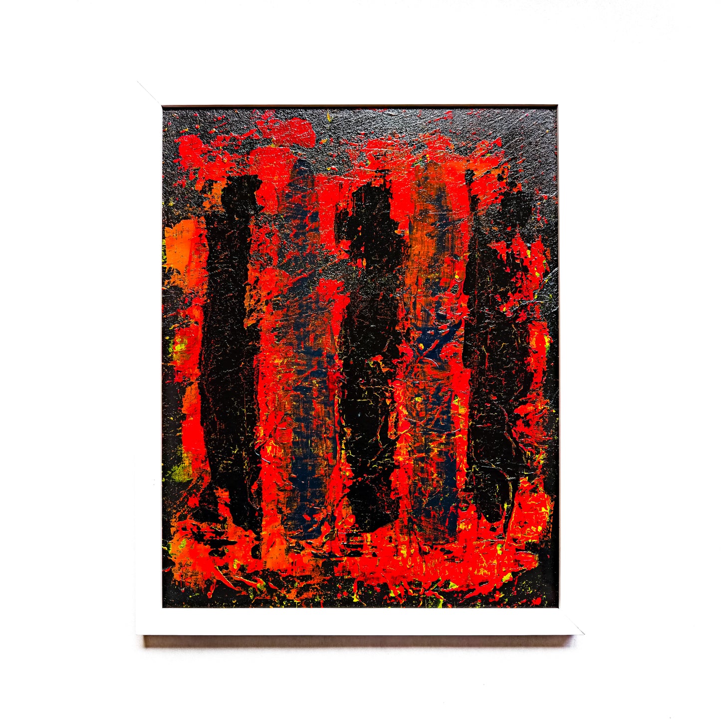Framed abstract painting with red, black and orange colours.