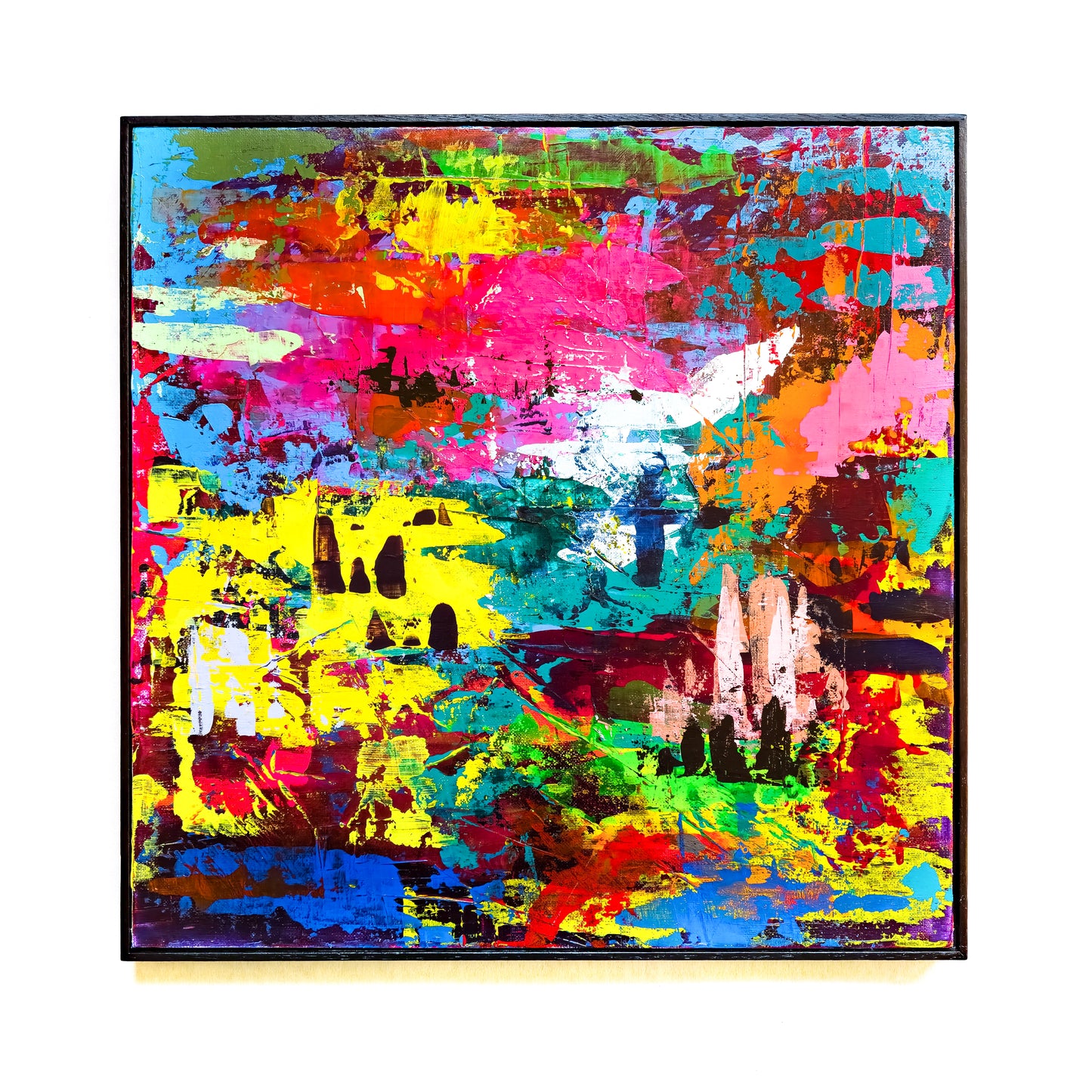 Abstract painting with vivid colours on a white wall.