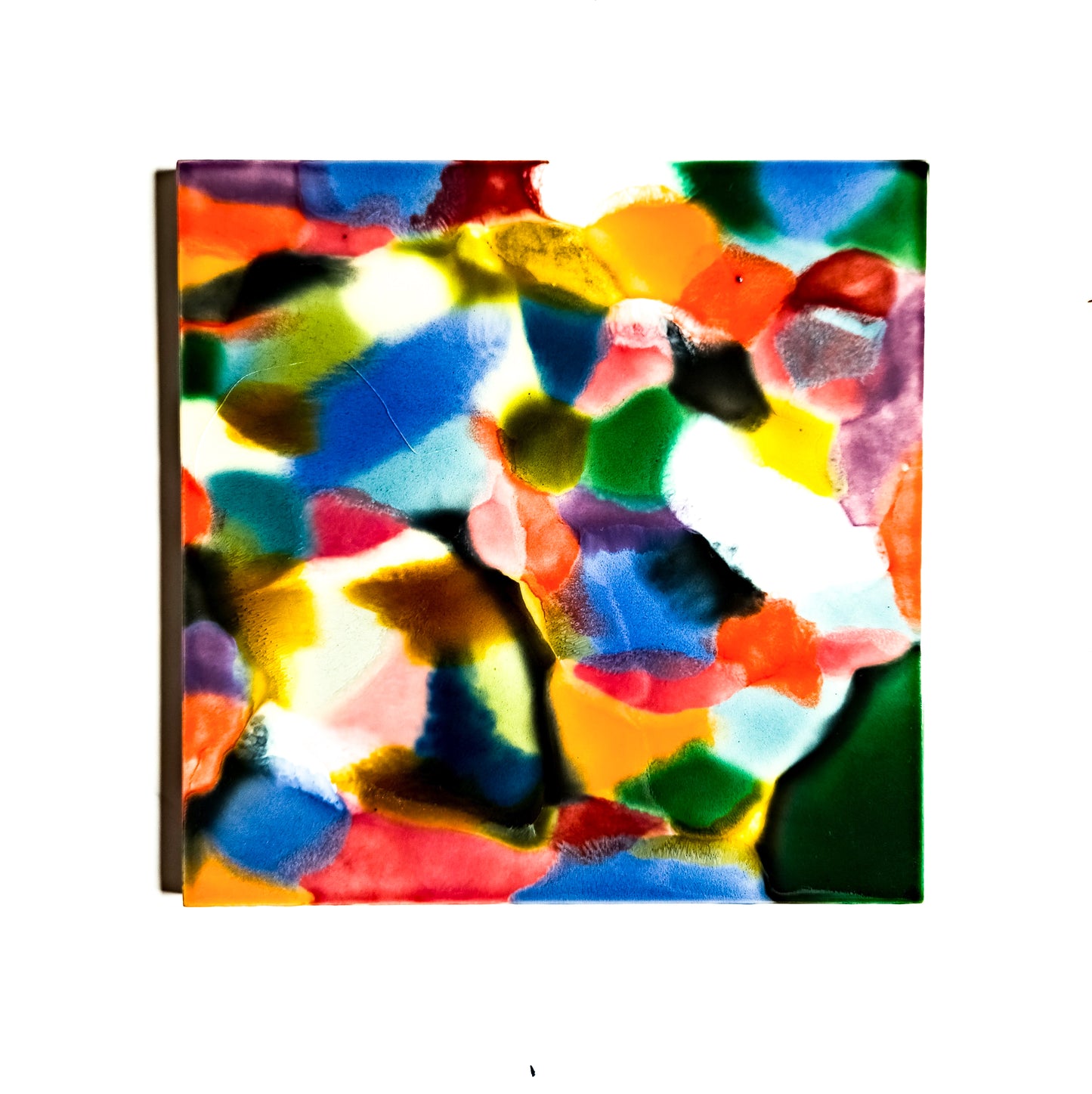 This image features a vibrant, abstract ceramic tile artwork titled "Patch." The artwork measures 6x6 inches and showcases an intense blend of multicolored patterns that evoke a sense of movement and energy.