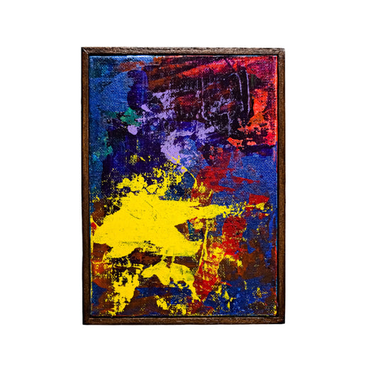 Abstract painting with vibrant colors on a white wall