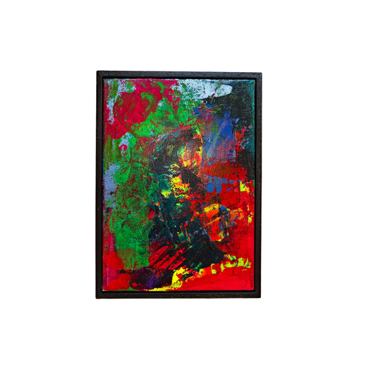 Framed abstract painting with vibrant colors on a white wall