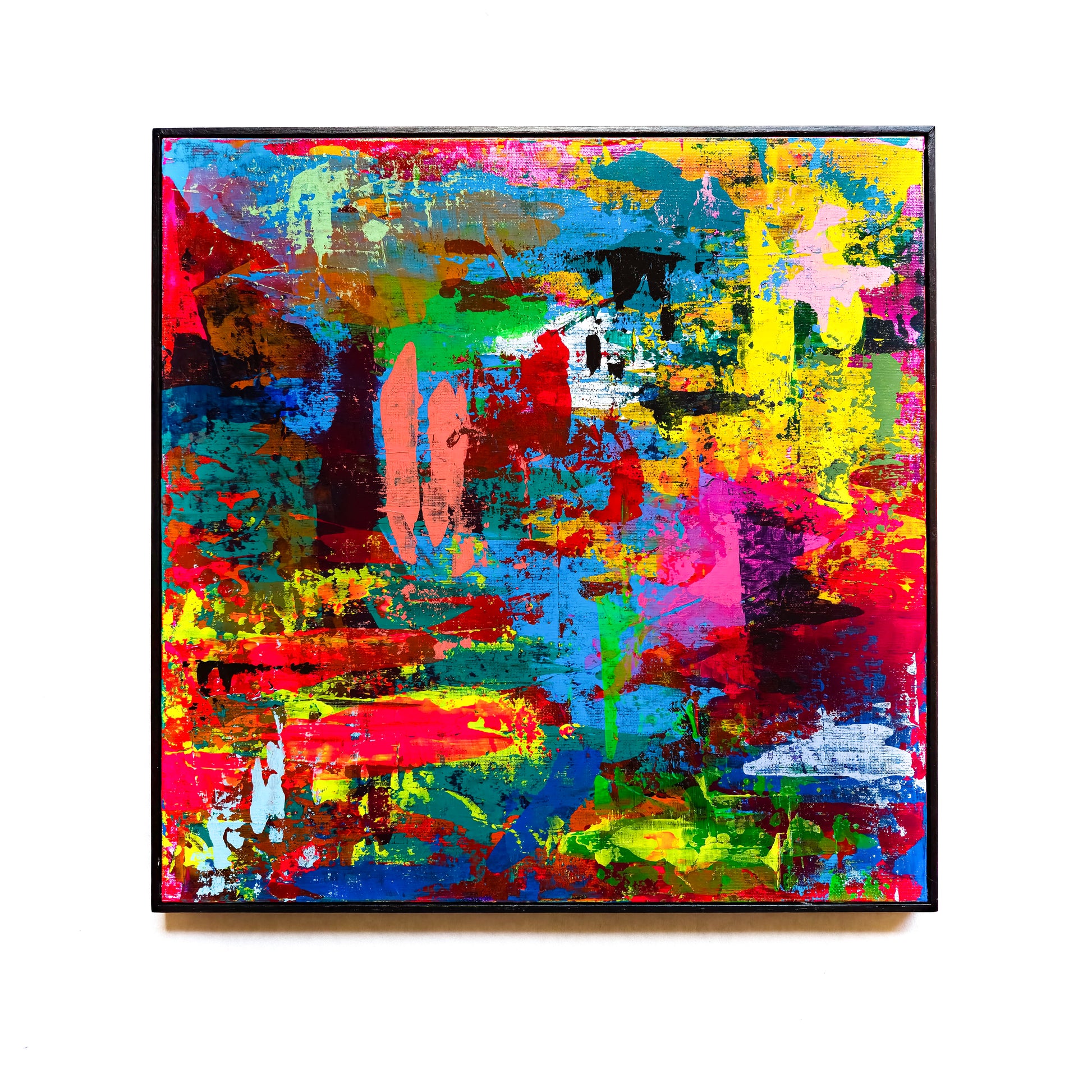 Abstract painting with vibrant colours on the white wall. 