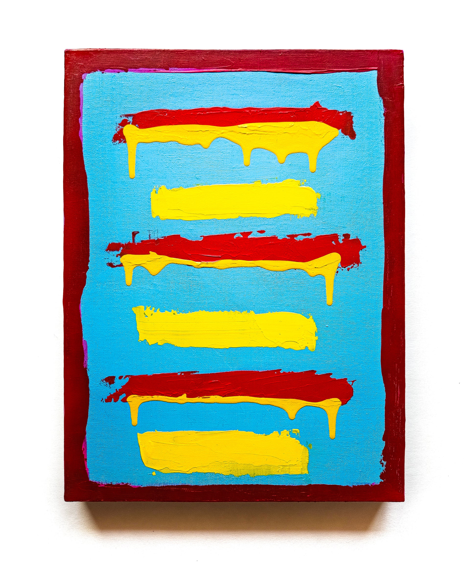 Abstract art piece with red and yellow horizontal strokes on a blue background