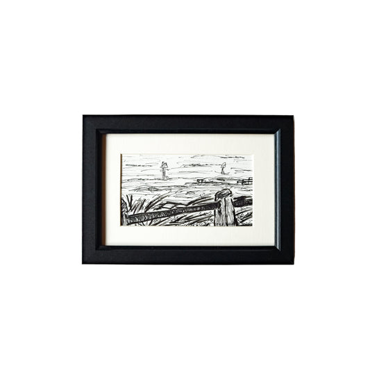 This image features a framed artwork titled "From the Boating Lake," created using acrylic ink and a fineliner. The artwork depicts a serene scene of a lake with boats and trees in the background, rendered in a minimalist style with a predominantly black and white color palette.